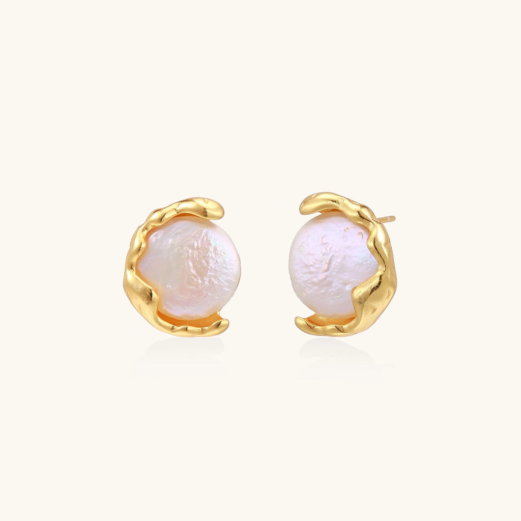 Gold-plated sterling silver stud earrings with organic claw settings cradling lustrous freshwater pearls on white background.