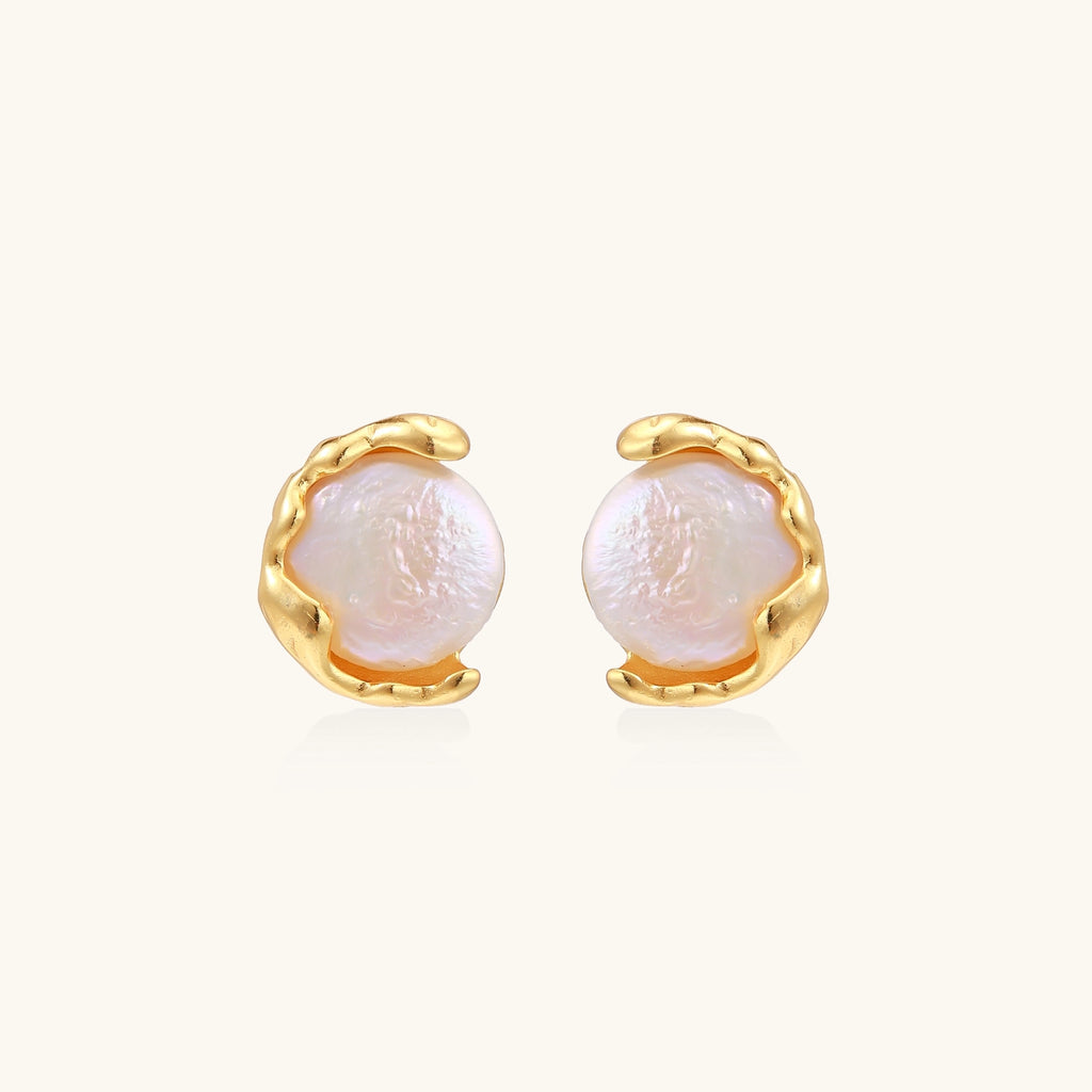 Gold-plated sterling silver stud earrings with organic claw settings cradling lustrous freshwater pearls on white background.