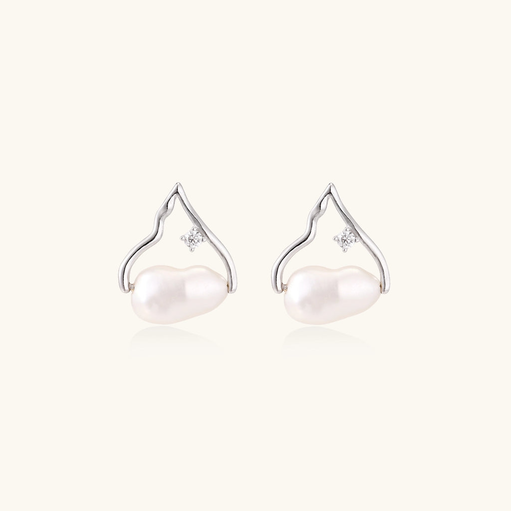 Sterling silver teardrop-shaped stud earrings with white freshwater pearls nestled in elegant flame-like frames