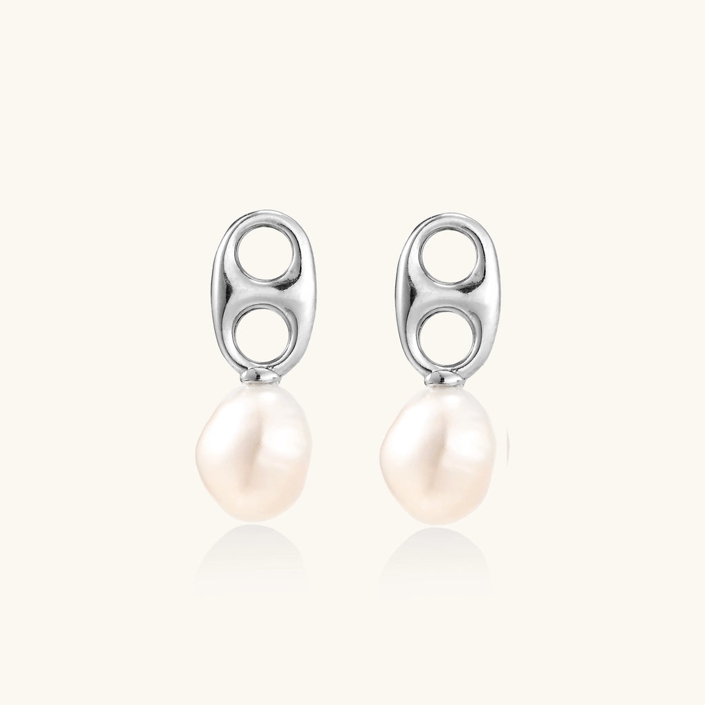Sterling silver oval stud earrings with dual circular cutouts and suspended freshwater pearls on white background.