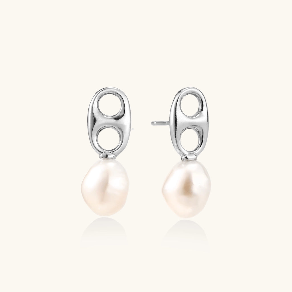 Sterling silver oval stud earrings with dual circular cutouts and suspended freshwater pearls on white background.