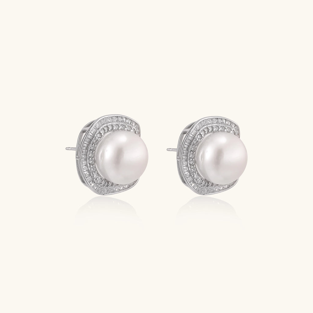 Sterling silver stud earrings with round freshwater pearls surrounded by sparkling crystal halos on white background.