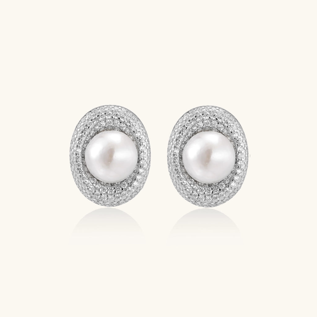 Sterling silver stud earrings with freshwater pearls surrounded by sparkling pavé crystals on white background.