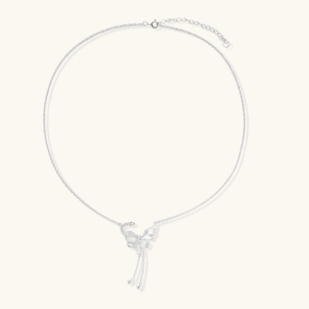 Delicate sterling silver butterfly pendant necklace with textured wing details and adjustable chain on white background