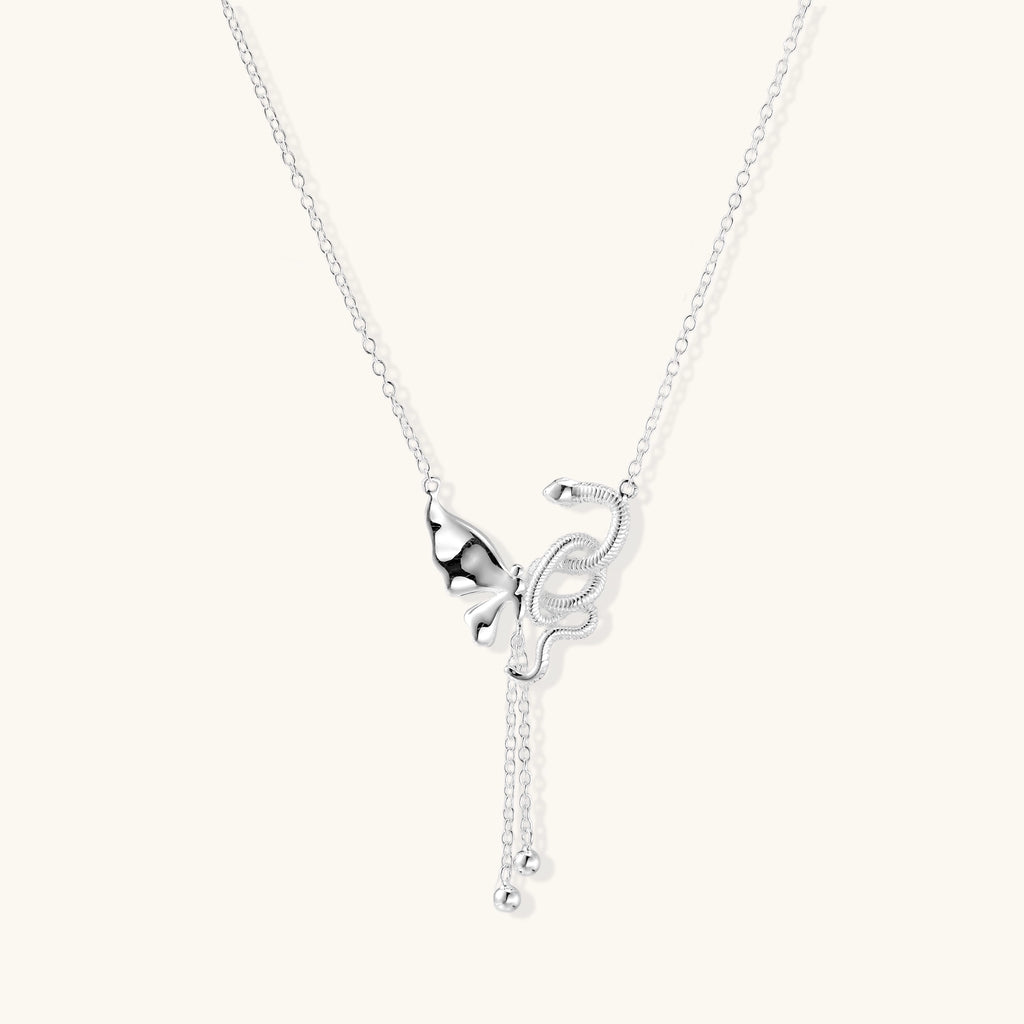 Delicate sterling silver butterfly pendant necklace with textured wing details and adjustable chain on white background