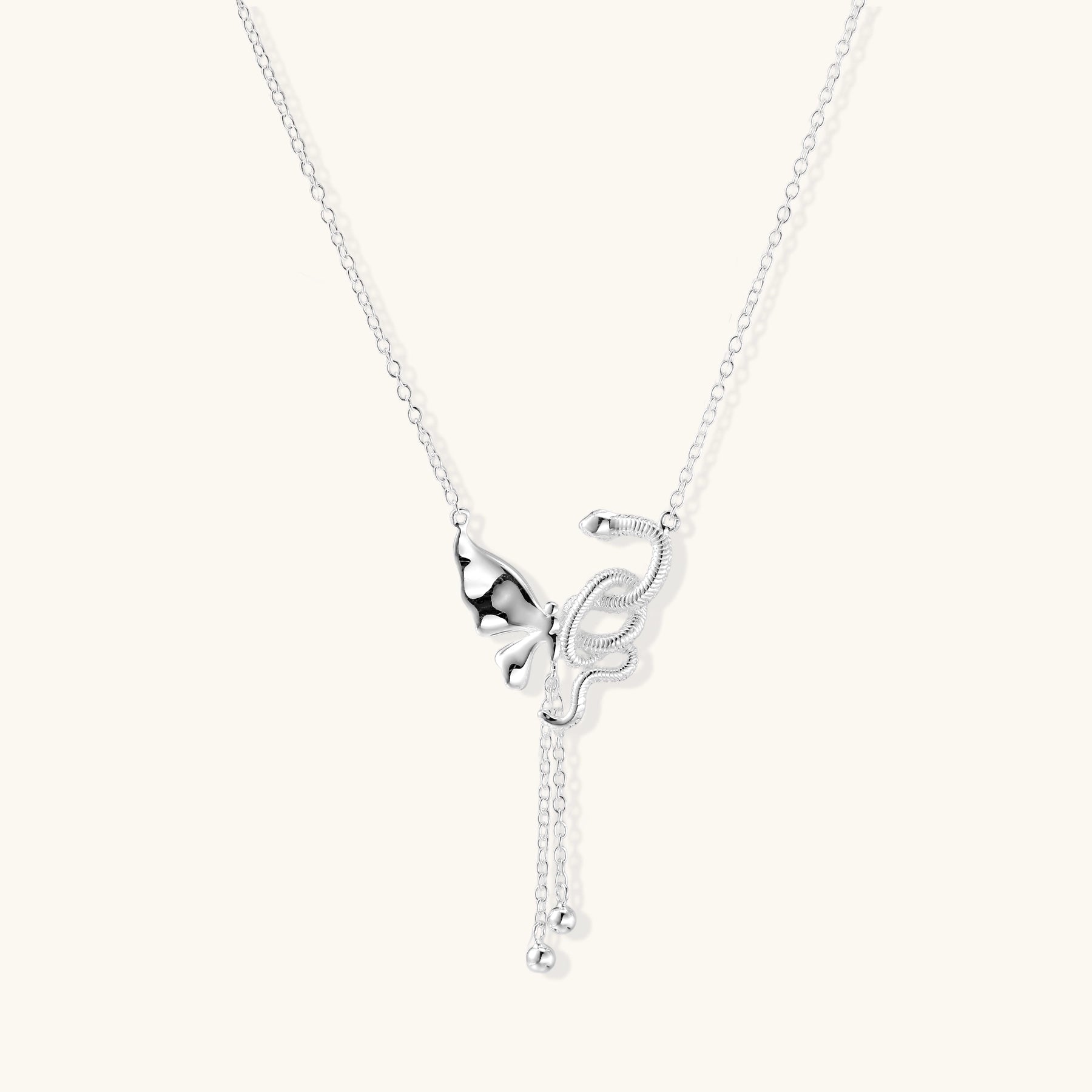 Delicate sterling silver butterfly pendant necklace with textured wing details and adjustable chain on white background