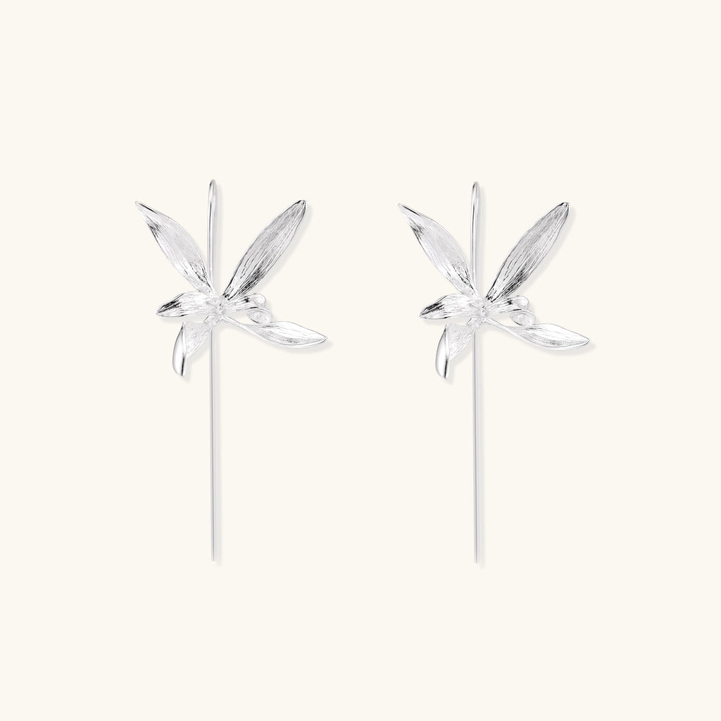 Delicate sterling silver flower earrings with long threader posts and five-petal design on white background.