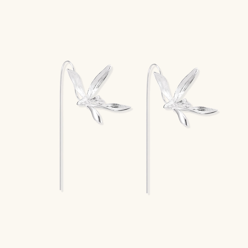 Delicate sterling silver flower earrings with long threader posts and five-petal design on white background.