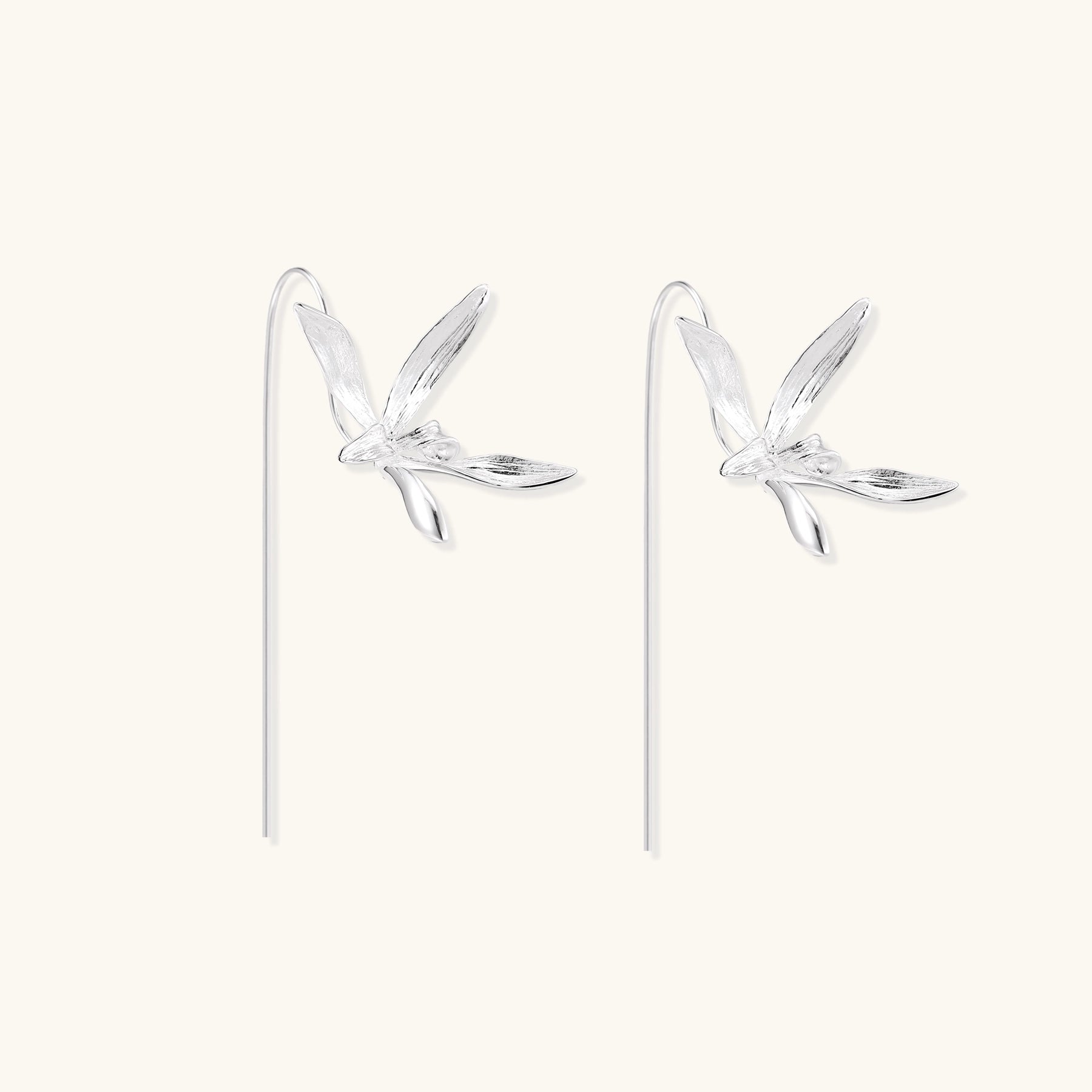 Delicate sterling silver flower earrings with long threader posts and five-petal design on white background.