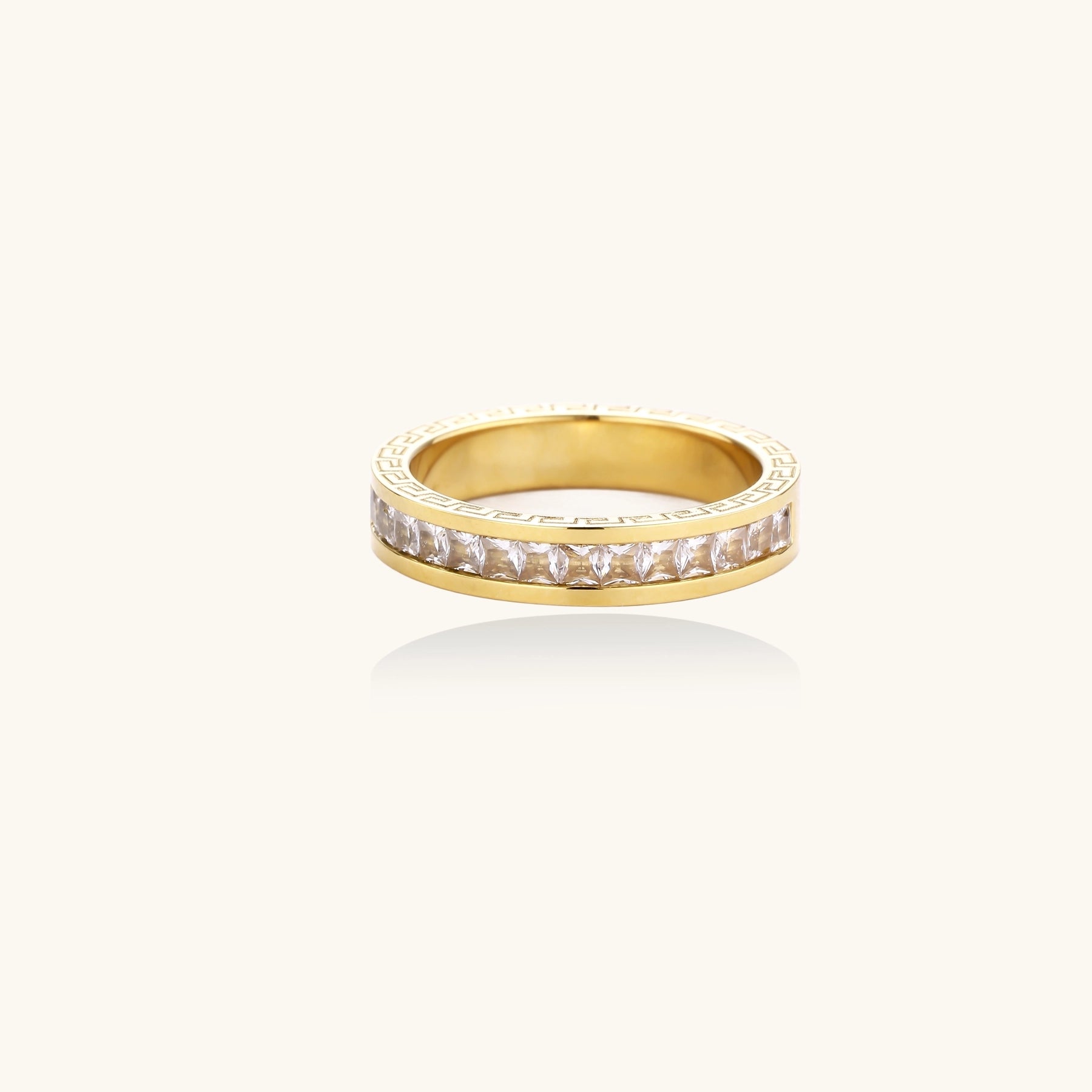 14K gold plated ring with channel-set zirconia stones and Greek key pattern engraved on sides on white background