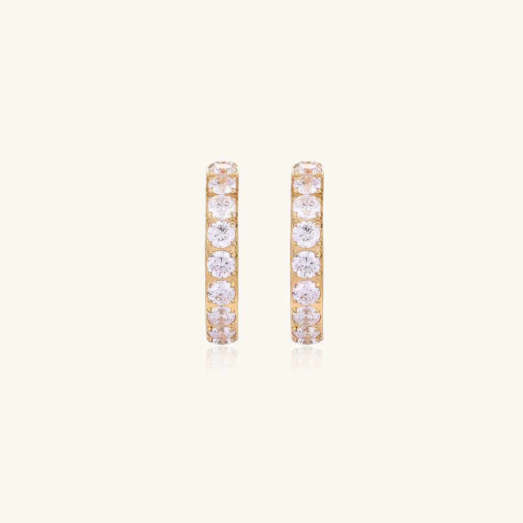 Gold-plated hoop earrings with crystal pavé and floating freshwater pearls inside the circular design.