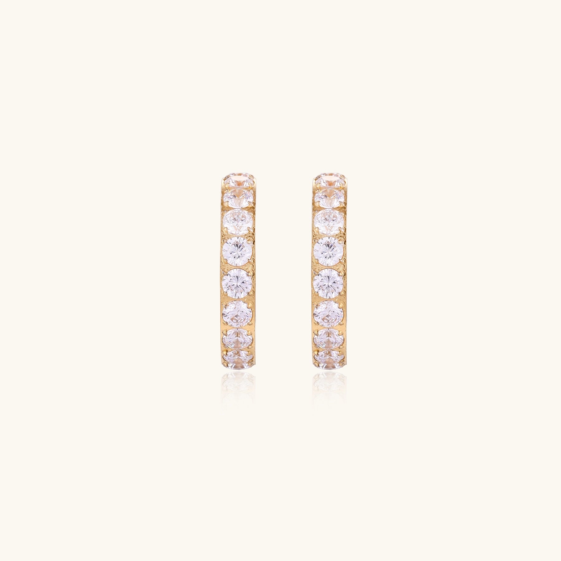 Gold-plated hoop earrings with crystal pavé and floating freshwater pearls inside the circular design.