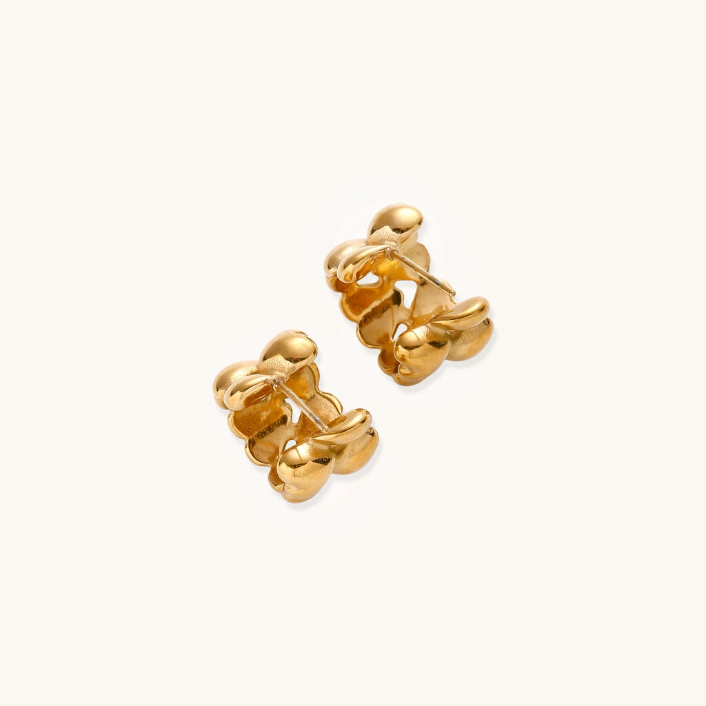 Small gold-plated hoop earrings with intricate braided texture pattern and post backs on white background.