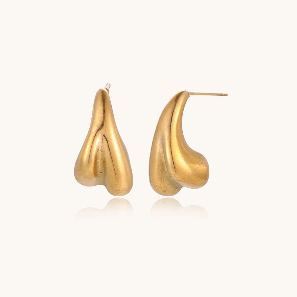Pair of gold-plated sculptural stud earrings with organic teardrop shapes on neutral background.