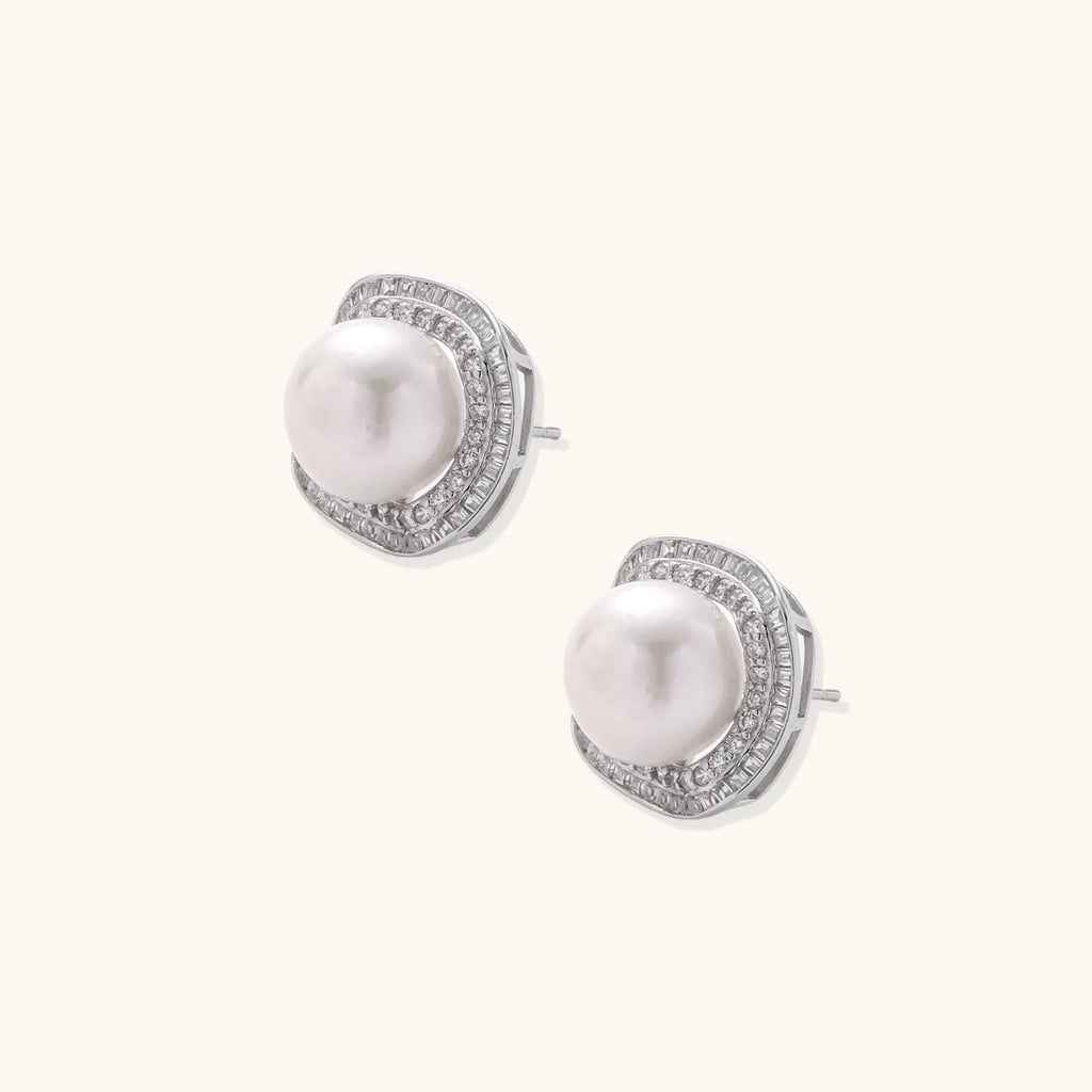 Cushion-shaped sterling silver stud earrings with freshwater pearls surrounded by geometric diamond halos